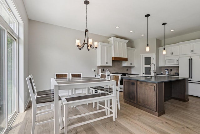 2322 Kae Ct, Mount Pleasant, WI 53406 - kitchen featuring white appliances, backsplash, a chandelier, dark countertops, and white cabinetry