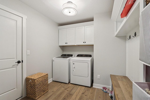 2322 Kae Ct, Mount Pleasant, WI 53406 - washroom with washing machine and dryer, light wood-type flooring, and cabinet space