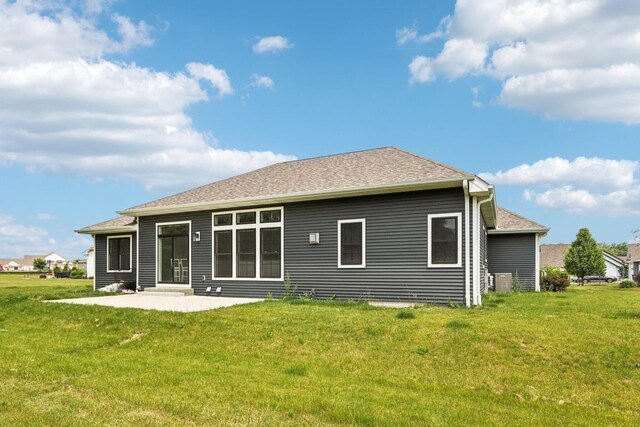 2322 Kae Ct, Mount Pleasant, WI 53406 - rear view of property featuring a patio and a lawn