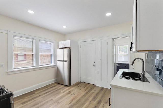 4423 N 30th St Unit 4425, Milwaukee, WI 53209 - kitchen featuring appliances with stainless steel finishes, light wood-style floors, white cabinetry, light countertops, and recessed lighting