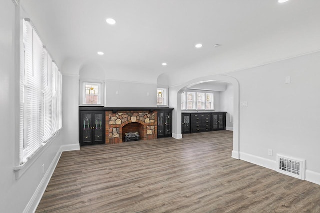 4423 N 30th St Unit 4425, Milwaukee, WI 53209 - unfurnished living room with a fireplace, wood finished floors, recessed lighting, and arched walkways