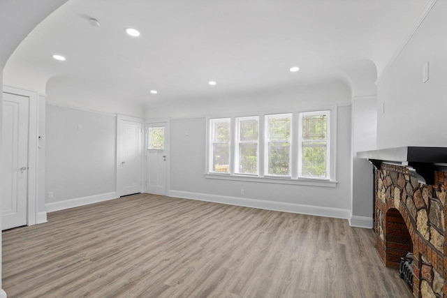 4423 N 30th St Unit 4425, Milwaukee, WI 53209 - unfurnished living room with light wood-type flooring, recessed lighting, and arched walkways