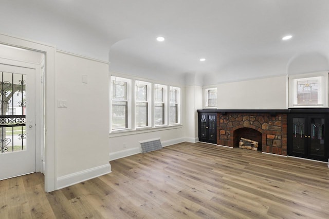 4423 N 30th St Unit 4425, Milwaukee, WI 53209 - unfurnished living room featuring wood finished floors, recessed lighting, and a stone fireplace