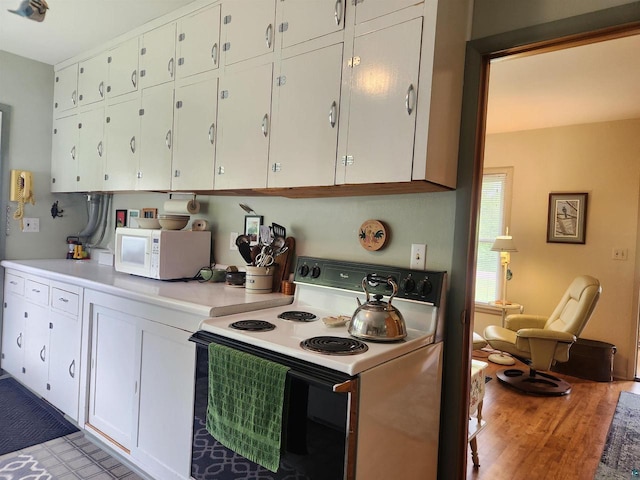 36805 N County Highway J, Bayfield, WI 54814 - kitchen with white appliances, white cabinetry, light countertops, and light wood-style floors