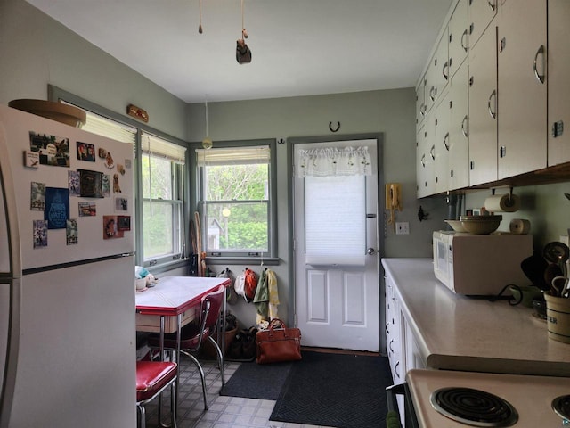 36805 N County Highway J, Bayfield, WI 54814 - kitchen with white appliances, white cabinetry, and tile patterned floors