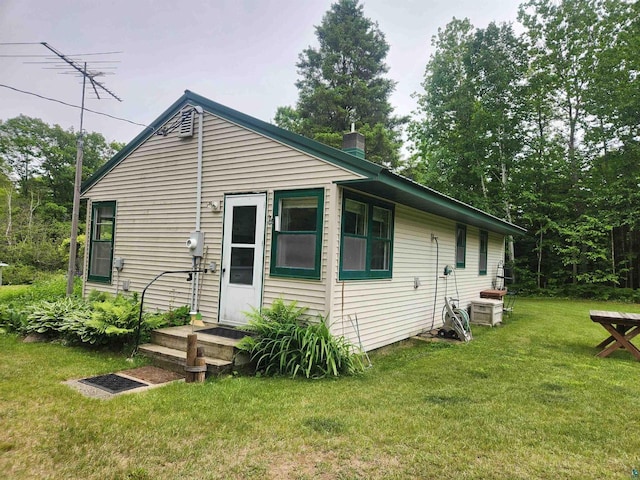 36805 N County Highway J, Bayfield, WI 54814 - rear view of house with a lawn and a chimney