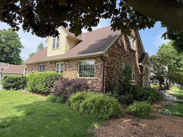 472 Orchard St, Burlington, WI 53105 - view of property exterior with brick siding, roof with shingles, and a yard