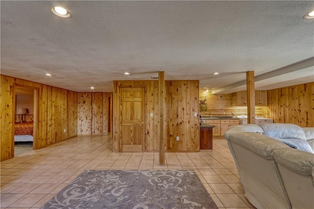 7766 Thunder Point Rd, Hayward, WI 54843 - living area with a textured ceiling, wood walls, light tile patterned floors, and recessed lighting