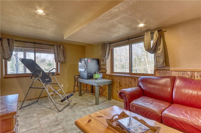 7766 Thunder Point Rd, Hayward, WI 54843 - living room featuring a textured ceiling, healthy amount of natural light, wood walls, recessed lighting, and light tile patterned floors