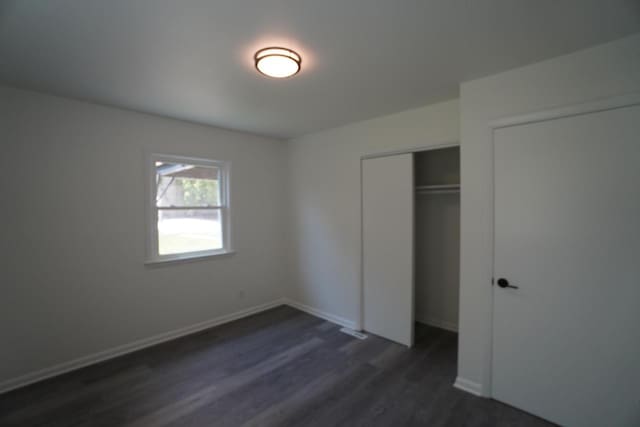 2881 S Linebarger Ter # 2883, Milwaukee, WI 53207 - unfurnished bedroom featuring dark wood-style floors and a closet