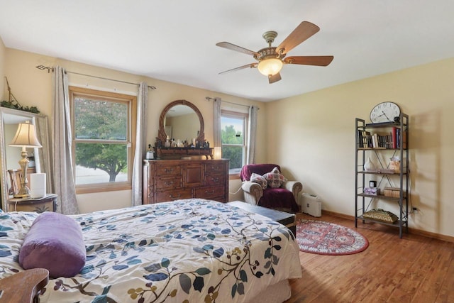 7170 S Countryside Dr, Franklin, WI 53132 - bedroom with wood finished floors, multiple windows, and ceiling fan