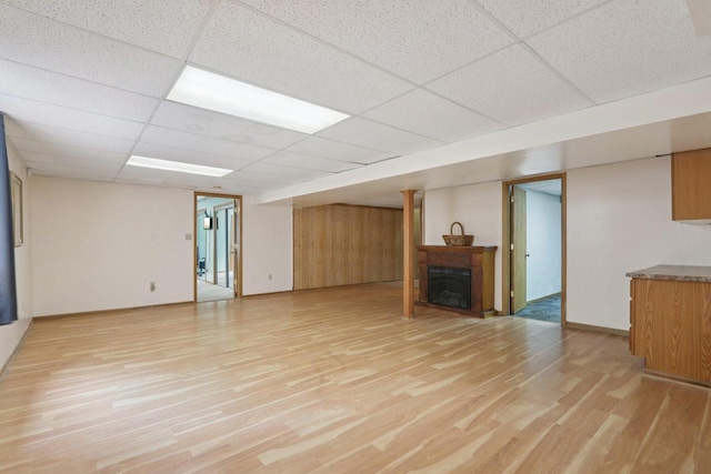 7170 S Countryside Dr, Franklin, WI 53132 - unfurnished living room with light wood finished floors, a drop ceiling, and a fireplace