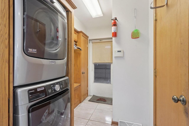 7170 S Countryside Dr, Franklin, WI 53132 - laundry room with estacked washer and dryer and light tile patterned floors
