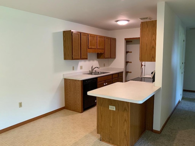 264 Minz Park Cir Unit 4, West Bend, WI 53095 - kitchen with dishwasher, brown cabinets, light countertops, and a peninsula