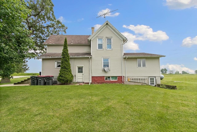 N2485 County Road Ii, Columbus, WI 53925 - rear view of house with a yard and a chimney