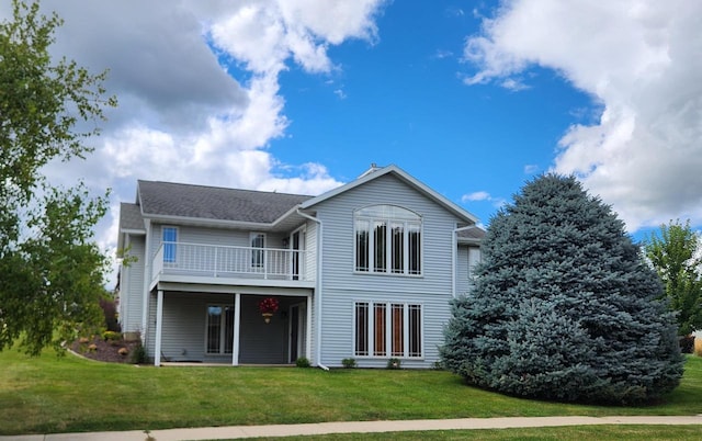 1227 N 3rd St, Monroe, WI 53566 - back of house featuring a lawn and a balcony