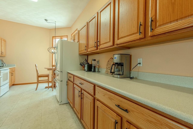 1227 N 3rd St, Monroe, WI 53566 - kitchen featuring white appliances, light countertops, and brown cabinetry