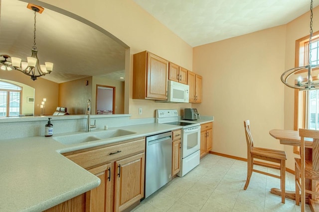 1227 N 3rd St, Monroe, WI 53566 - kitchen featuring a chandelier, white appliances, arched walkways, and light countertops