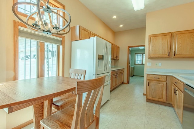 1227 N 3rd St, Monroe, WI 53566 - kitchen with white refrigerator with ice dispenser, dishwasher, light countertops, a chandelier, and light brown cabinets