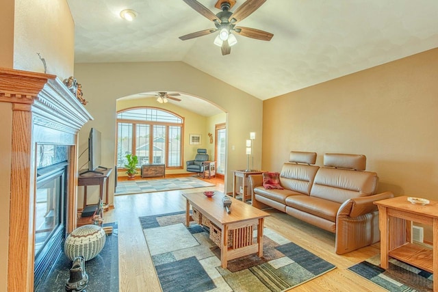 1227 N 3rd St, Monroe, WI 53566 - living area with arched walkways, a ceiling fan, wood finished floors, and vaulted ceiling