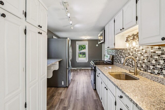 1383 Range Trl, Verona, WI 53593 - kitchen featuring stainless steel appliances, white cabinetry, decorative backsplash, and dark wood-style flooring