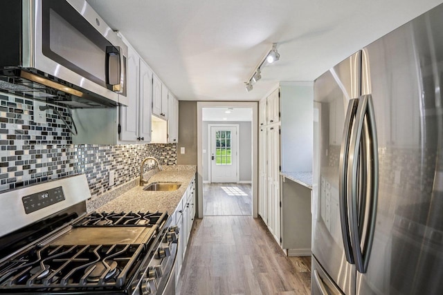 1383 Range Trl, Verona, WI 53593 - kitchen with appliances with stainless steel finishes, wood finished floors, decorative backsplash, rail lighting, and white cabinets