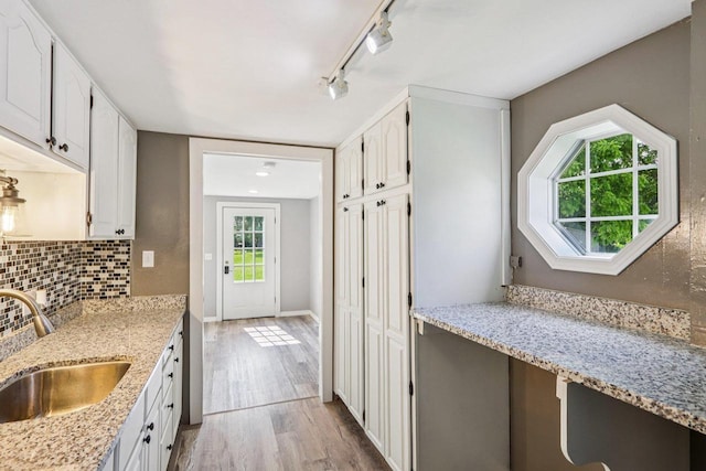 1383 Range Trl, Verona, WI 53593 - kitchen with track lighting, light wood finished floors, white cabinets, backsplash, and light stone countertops