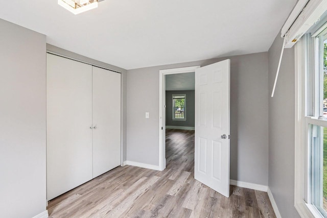 1383 Range Trl, Verona, WI 53593 - unfurnished bedroom featuring light wood-style flooring and a closet