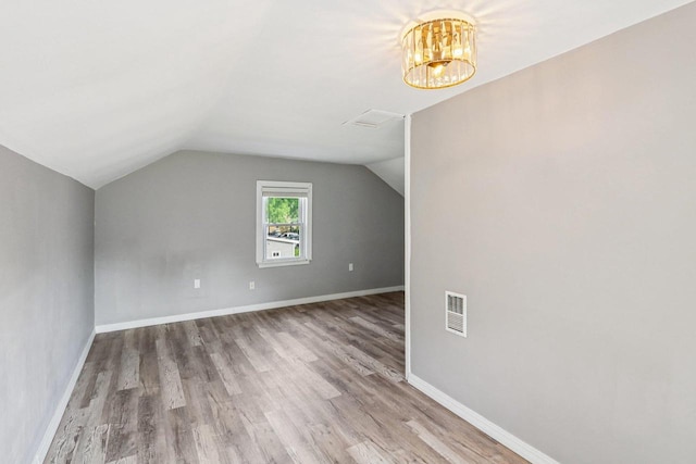 1383 Range Trl, Verona, WI 53593 - bonus room featuring wood finished floors, vaulted ceiling, and a chandelier