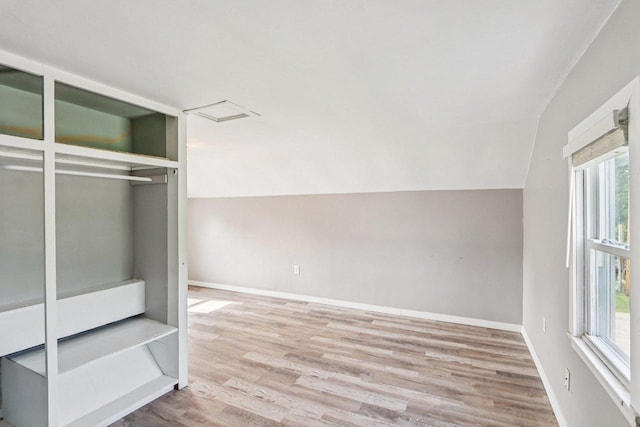 1383 Range Trl, Verona, WI 53593 - unfurnished bedroom featuring multiple windows, wood finished floors, and lofted ceiling