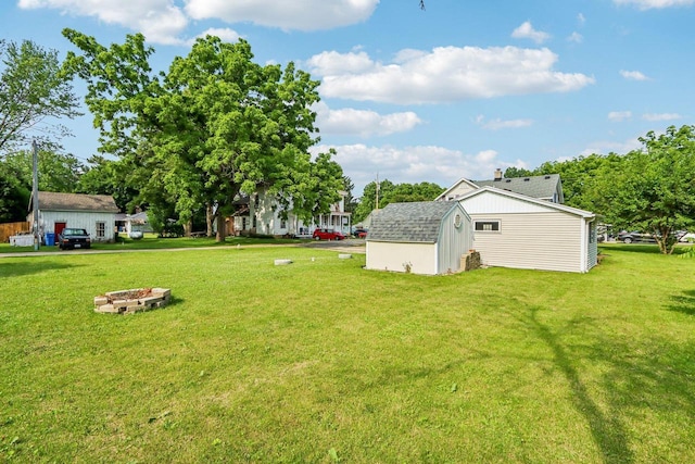 1383 Range Trl, Verona, WI 53593 - view of grassy yard with a storage shed and an outdoor fire pit