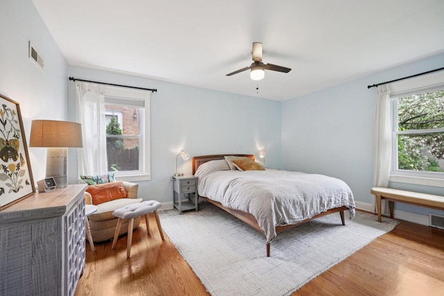 3154 N 82nd St, Milwaukee, WI 53222 - bedroom with light wood-type flooring, multiple windows, and ceiling fan