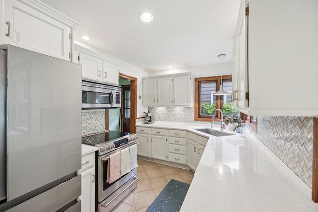 3154 N 82nd St, Milwaukee, WI 53222 - kitchen featuring appliances with stainless steel finishes, tasteful backsplash, white cabinetry, light countertops, and recessed lighting