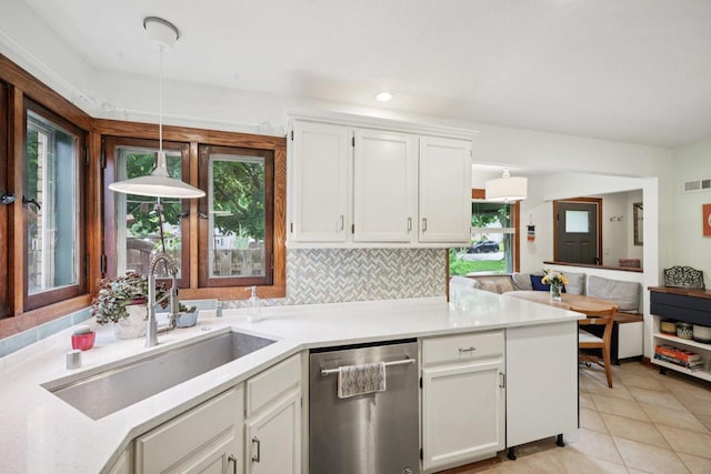 3154 N 82nd St, Milwaukee, WI 53222 - kitchen featuring stainless steel dishwasher, white cabinetry, hanging light fixtures, light tile patterned flooring, and light countertops