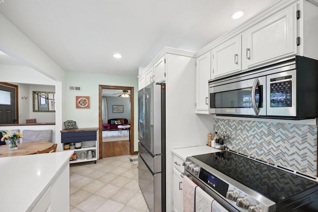 3154 N 82nd St, Milwaukee, WI 53222 - kitchen featuring appliances with stainless steel finishes, light countertops, tasteful backsplash, white cabinets, and light tile patterned flooring