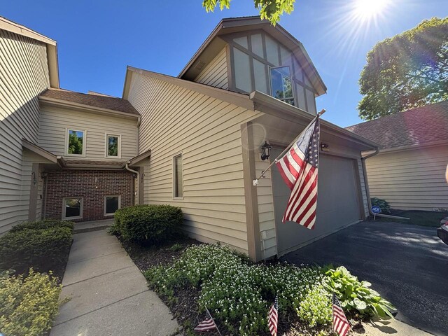 N34W23849 Grace Ave Unit C, Pewaukee, WI 53072 - view of home's exterior featuring asphalt driveway