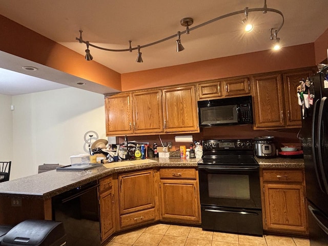 N34W23849 Grace Ave Unit C, Pewaukee, WI 53072 - kitchen with black appliances, brown cabinets, a peninsula, and light tile patterned flooring