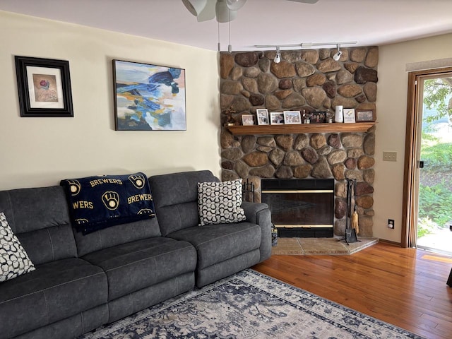 N34W23849 Grace Ave Unit C, Pewaukee, WI 53072 - living room featuring rail lighting, wood finished floors, a ceiling fan, and a fireplace