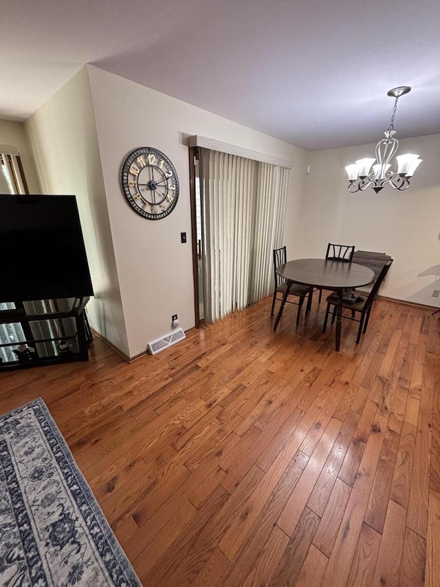 N34W23849 Grace Ave Unit C, Pewaukee, WI 53072 - dining room featuring wood-type flooring and a chandelier