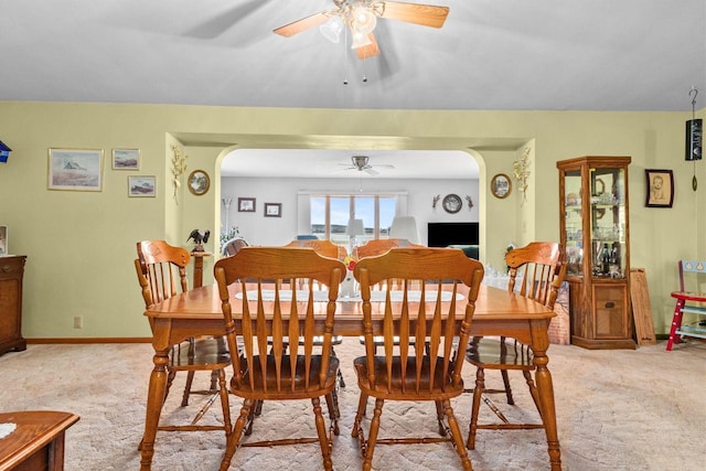 230 Gilbertson St, Markesan, WI 53946 - dining area with ceiling fan, light colored carpet, and arched walkways
