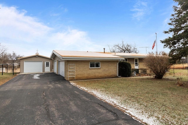 230 Gilbertson St, Markesan, WI 53946 - ranch-style home with a detached garage, brick siding, and a front yard