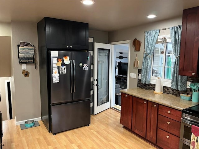 3158 Leslie Ln, Eau Claire, WI 54703 - kitchen featuring freestanding refrigerator, light wood finished floors, tasteful backsplash, light countertops, and electric range