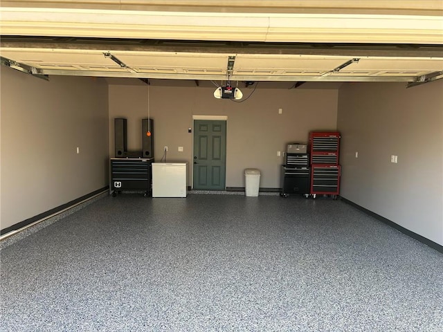 3158 Leslie Ln, Eau Claire, WI 54703 - garage featuring a garage door opener, refrigerator, and electric panel