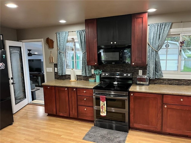 3158 Leslie Ln, Eau Claire, WI 54703 - kitchen with black appliances, light wood-style flooring, backsplash, recessed lighting, and a ceiling fan