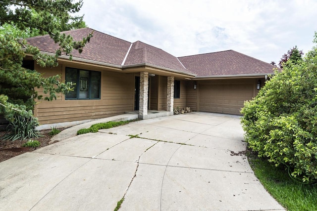 3381 S Highpointe Dr, New Berlin, WI 53151 - view of front of property with driveway, an attached garage, a porch, and roof with shingles