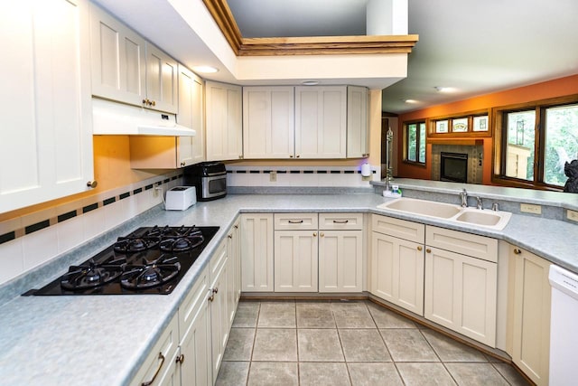 3381 S Highpointe Dr, New Berlin, WI 53151 - kitchen with under cabinet range hood, white dishwasher, light countertops, and black gas stovetop