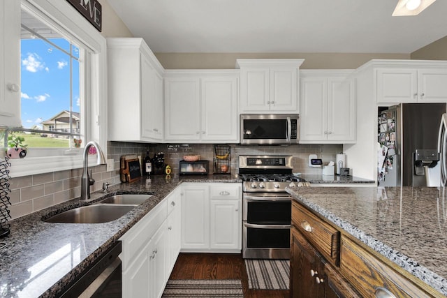 1395 American Eagle Dr, Slinger, WI 53086 - kitchen with appliances with stainless steel finishes, dark wood-type flooring, white cabinetry, and stone counters