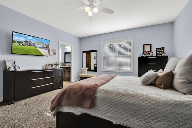 1395 American Eagle Dr, Slinger, WI 53086 - bedroom with light colored carpet, ensuite bath, and a ceiling fan