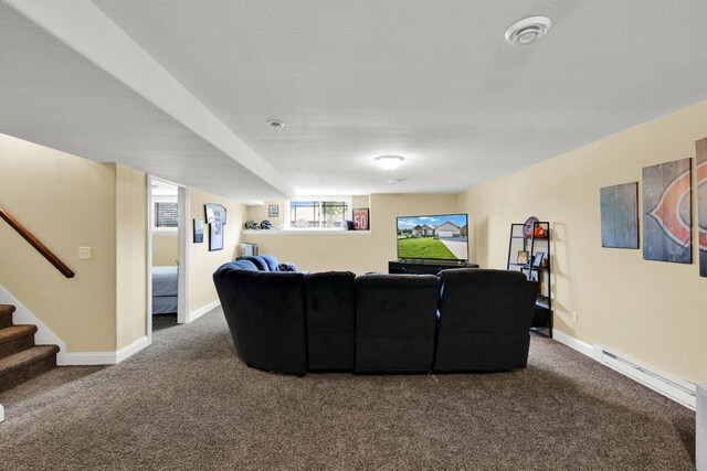 1395 American Eagle Dr, Slinger, WI 53086 - living room with dark colored carpet, stairs, and a baseboard heating unit