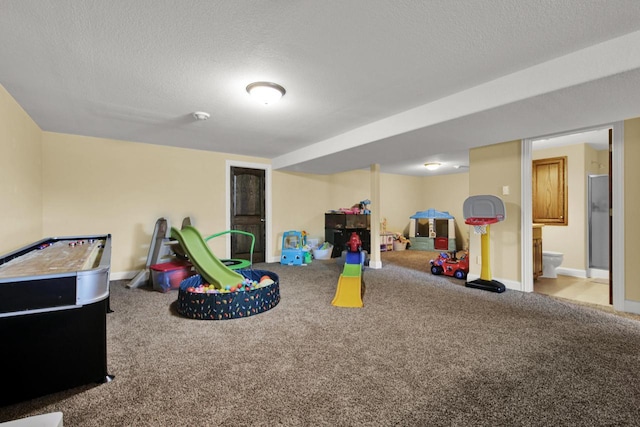 1395 American Eagle Dr, Slinger, WI 53086 - recreation room featuring carpet and a textured ceiling